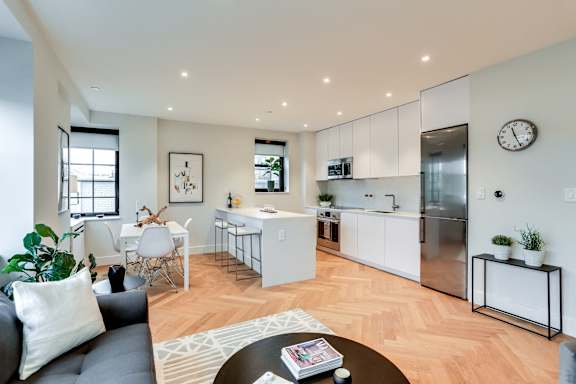 Open concept living and dining rooms with brand new hardwood flooring