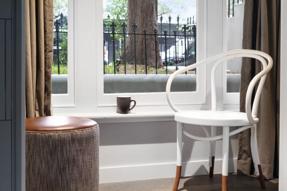 a chair and a table in front of a window