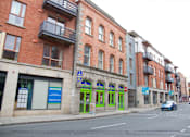 Thumbnail 4 of 6 - a city street with buildings and a car on it