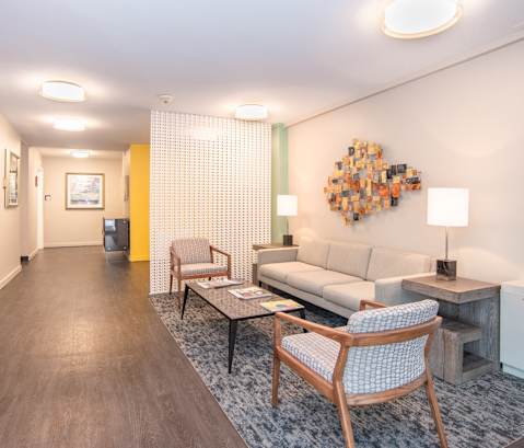 a living room with a couch and chairs and a table