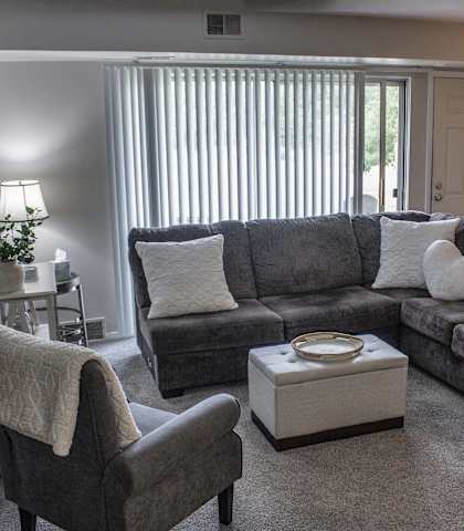 a living room with a couch and two chairs