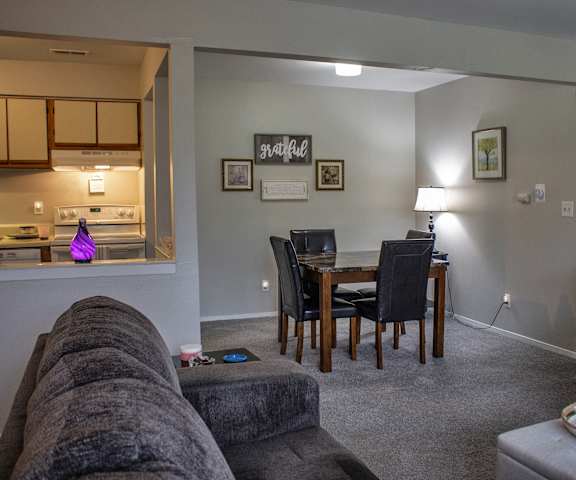 a living room and dining room with a couch and a table