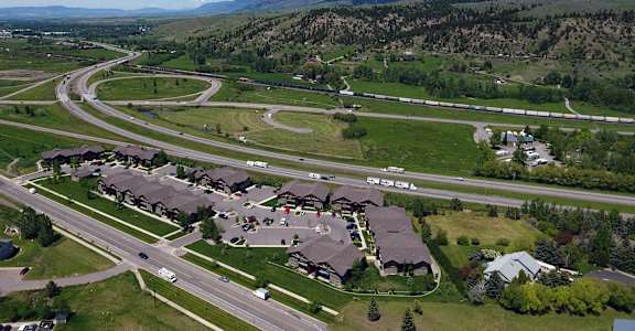 A suburban neighborhood with houses and a winding road.