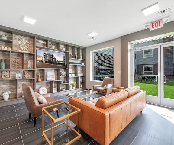 A living room with a brown couch, a chair, and a coffee table.