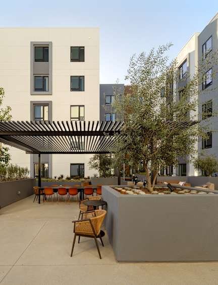 A modern apartment complex with multiple buildings and balconies.