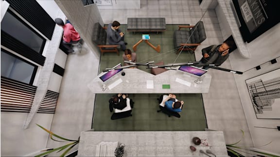 a group of people sitting around a table in an office