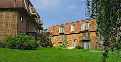 A building with a green lawn in front.