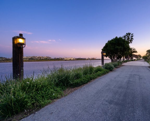 a street with houses and a river at dusk