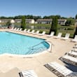 an aerial view of a swimming pool with lounge chairs around it