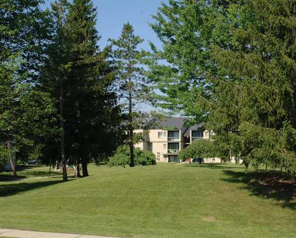 a large lawn in front of an apartment building