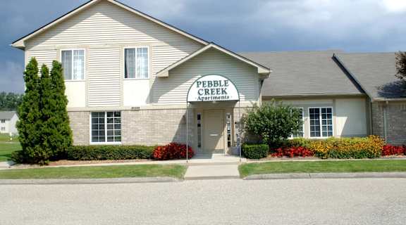 a white house with a sign on the front of it