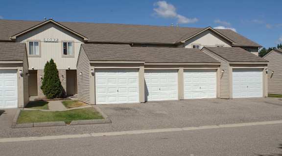 a house with white garage doors in front of it