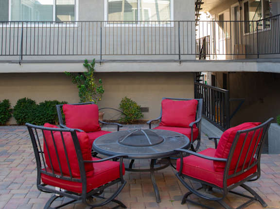 A patio with a table and chairs.