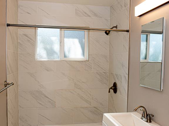a small bathroom with a shower and a sink