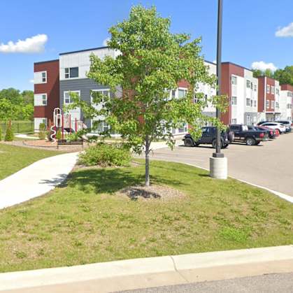 A parking lot in front of a building with a sign that says "Heights".