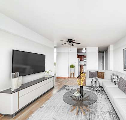 Modern living room at Buena Shores apartments in Chicago’s Buena Park neighborhood featuring large windows, hardwood floors, and contemporary furnishings.