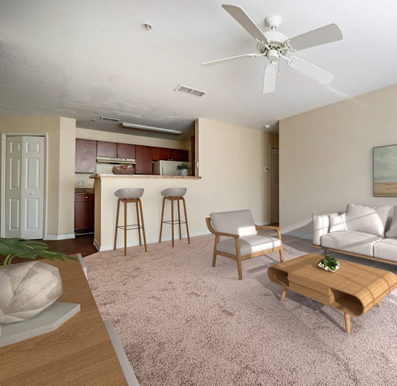 a dining room and living room area with a table and chairs and a couch in the background