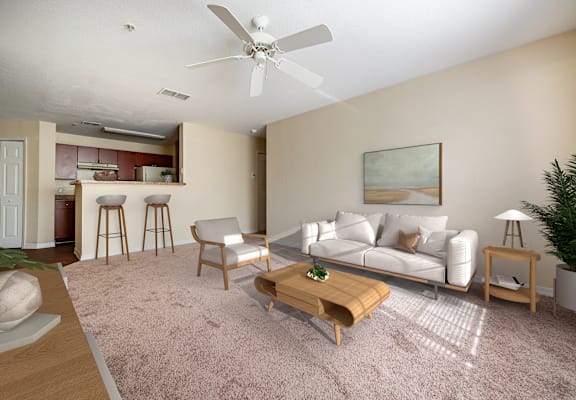 A living room with a white couch, a wooden coffee table, and a ceiling fan.