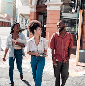 Four people walking on a city street.