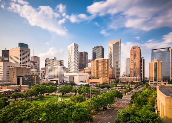 A cityscape with tall buildings and a clear sky.
