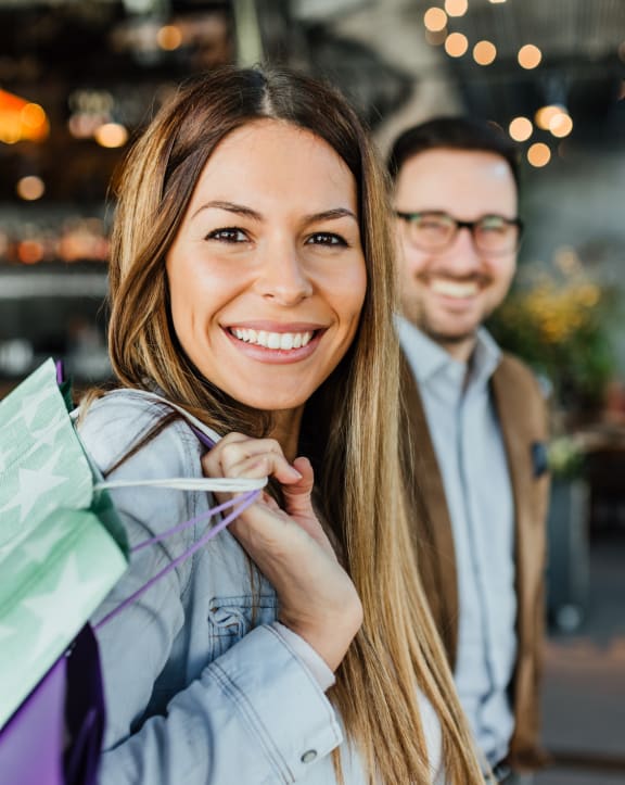 portrait of a young couple with shopping bags in a restaurant