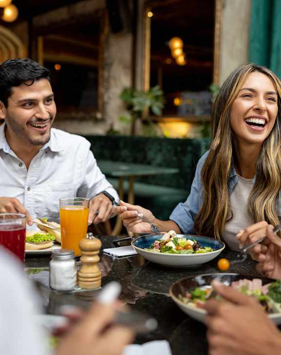 A group of people are having a meal together at a restaurant.