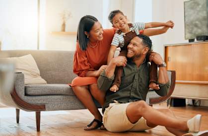 a family is sitting on the floor in a living room