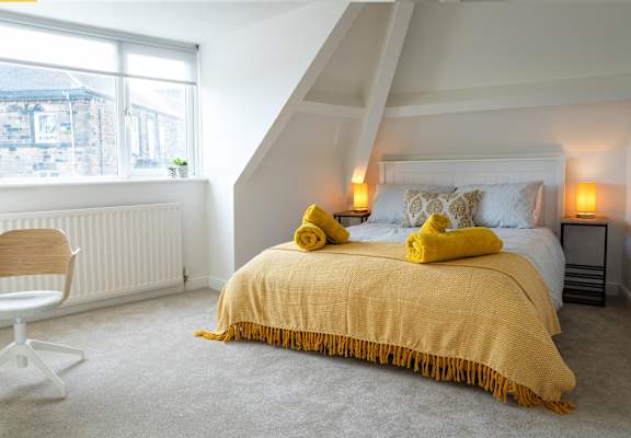 a bedroom with a bed and a window