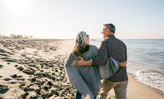 an older couple walking on the beach at 55+ Remington at Ladera Ranch, Ladera Ranch, CA