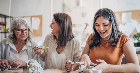 three women sitting at a table making crafts together at Allure at Edinburgh, Chesapeake, VA, 23322