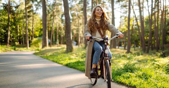 a woman riding a bike down a road at Ellis Station, Durham, North Carolina