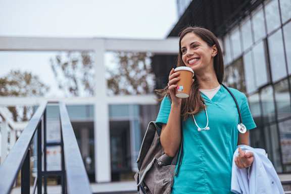 a woman in a blue dress holding a cup of coffee