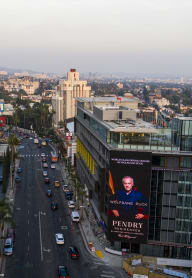 a city street with a large billboard on the side of a building