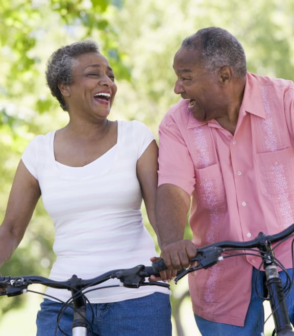 a man and a woman riding their bikes at Oak Grove at Blake Farm, Wilmington, North Carolina