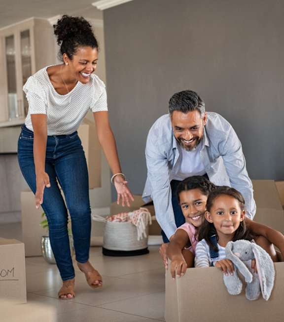 A family of four is unpacking boxes in their new home.