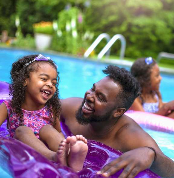 A family enjoying a day at the pool.