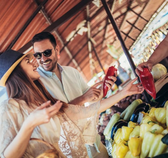a couple buys fruit at a market  at The Griffin Royal Oak, Royal Oak, Michigan