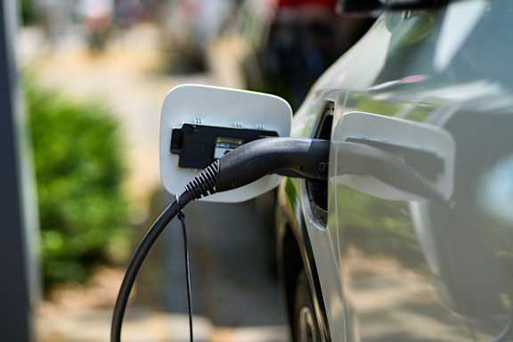 An electric car is plugged into a charging station.