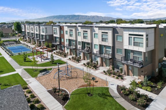 Apartment complex with a playground and a pool.