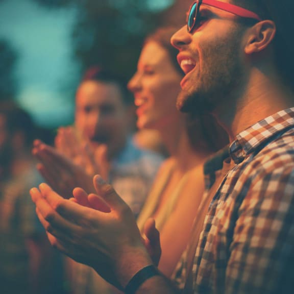 people at a concert applauding