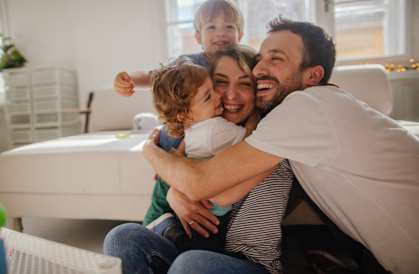 a man and woman sitting on a couch with a child