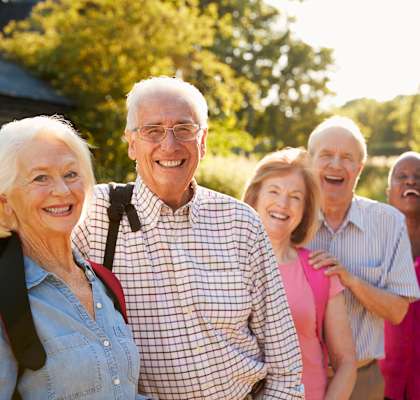 a group of people standing in a line and smiling