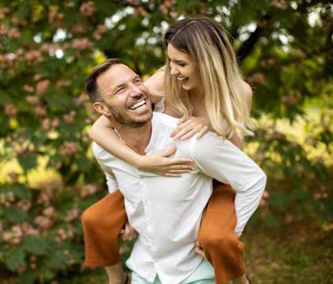 a man carrying a woman on his back at North Grove, Riverside