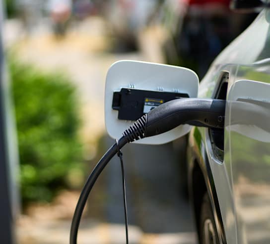 An electric car is plugged into a charging station.