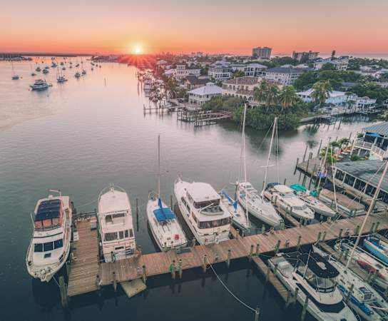 a harbor filled with boats at sunset at Promenade at Reflection Lakes, Florida, 33907