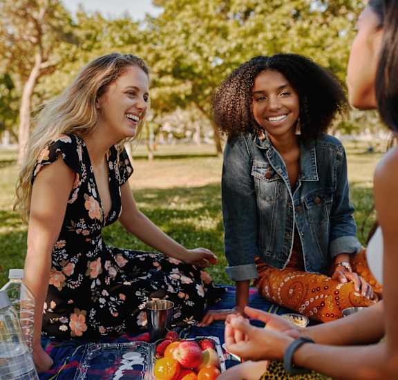 a group of women having a picnic in the park at High Oaks, Austin, 78759
