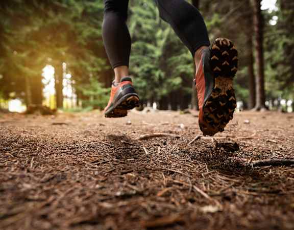 a person running on a trail in the woods at VALE Lake Wylie Apartments, Clover , SC