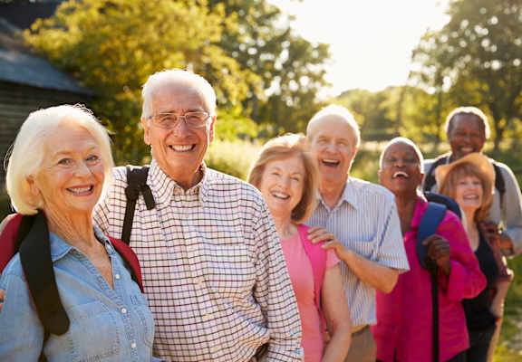 a group of people standing in a line and smiling