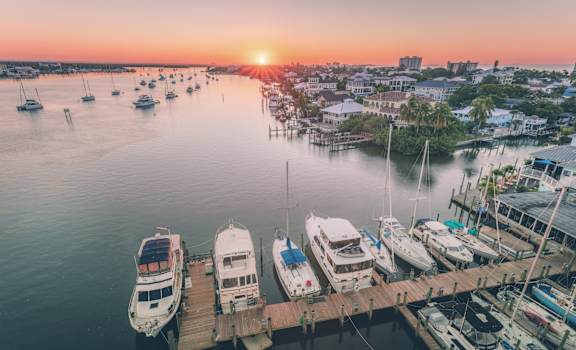 a harbor filled with boats at sunset at Bay Harbor, Fort Myers, Florida