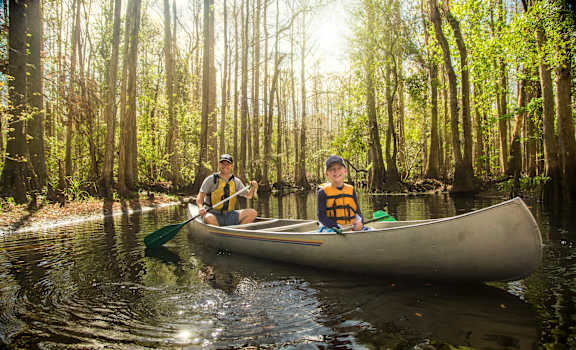 two boys in a canoe on a river at Floresta, Florida